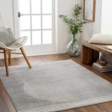 Entryway with gray Beauregard Area Rug, white chair, wood bench, and natural light. Contemporary geometric style. Roomscene-Rectangle