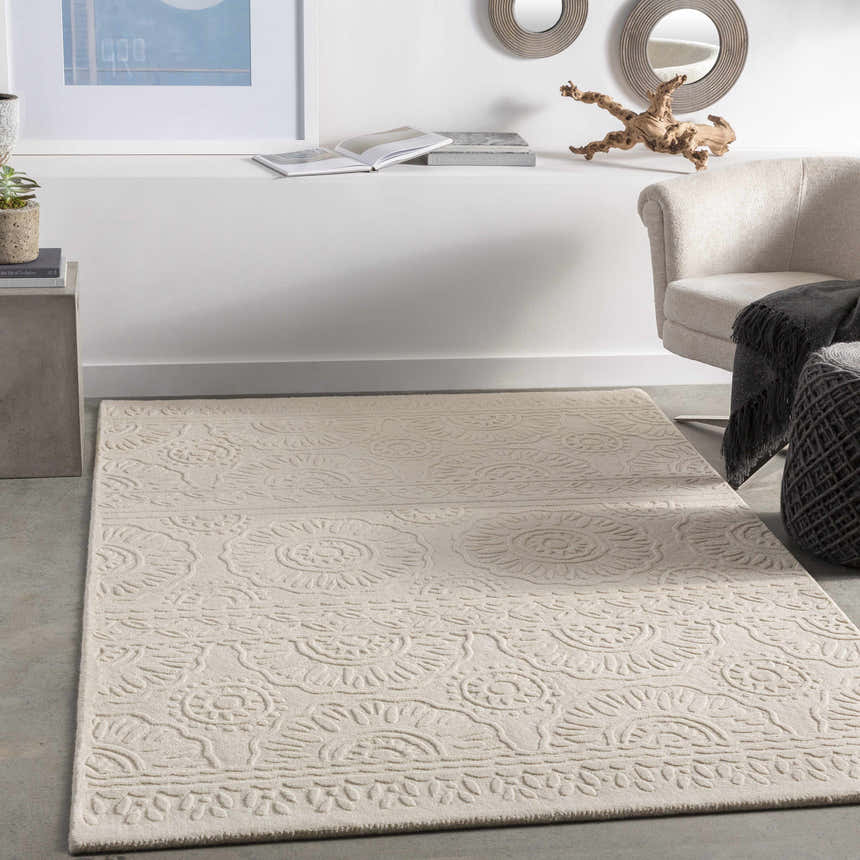 Living room scene with beige Beighton Clearance Rug, light beige chair, and modern decor on a shelf. Roomscene-Rectangle