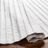 Close-up of the light gray Benek Area Rug showing its hand woven geometric pattern and recycled PET yarn texture. Fold