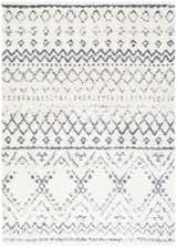 Close-up of the Benezett Area Rug featuring a gray and white bohemian-inspired geometric pattern. Shag texture. Design-Rectangle-5373