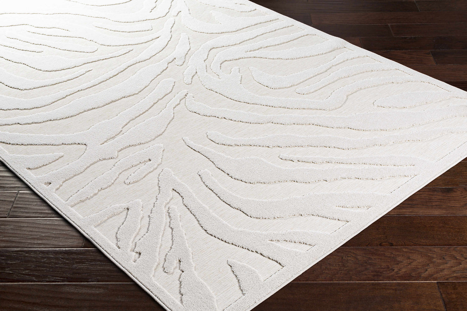 Close-up of the Benzonia 3D White Zebra Rug showing its light beige color and textured zebra stripe pattern. Corner