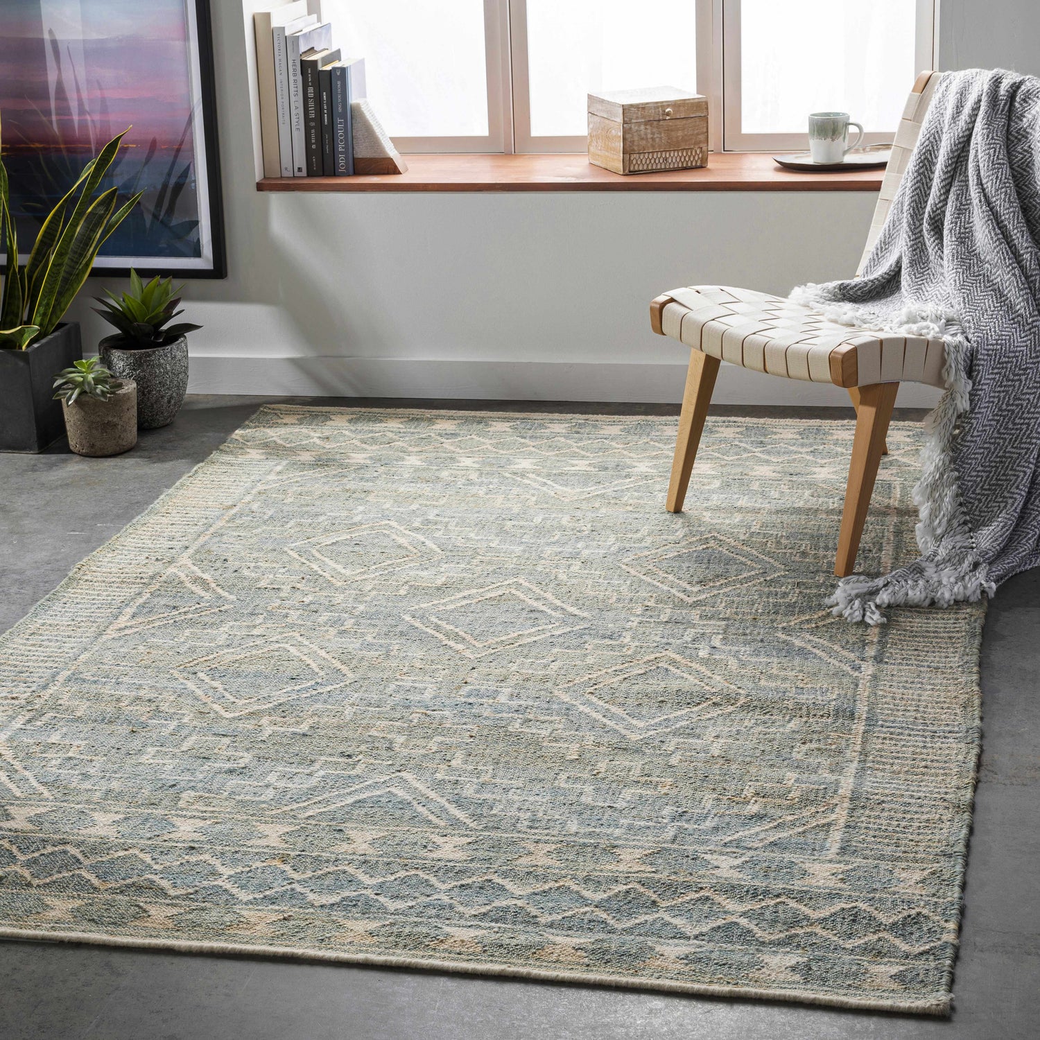 Living room scene with a Berowra Jute Rug in dusty sage and ivory, styled with a chair and natural light. Roomscene-Rectangle