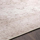Close-up of the beige Bethany Vintage Flat Pile Washable Rug showing its subtle, traditional pattern and chenille-polyester texture. Pile
