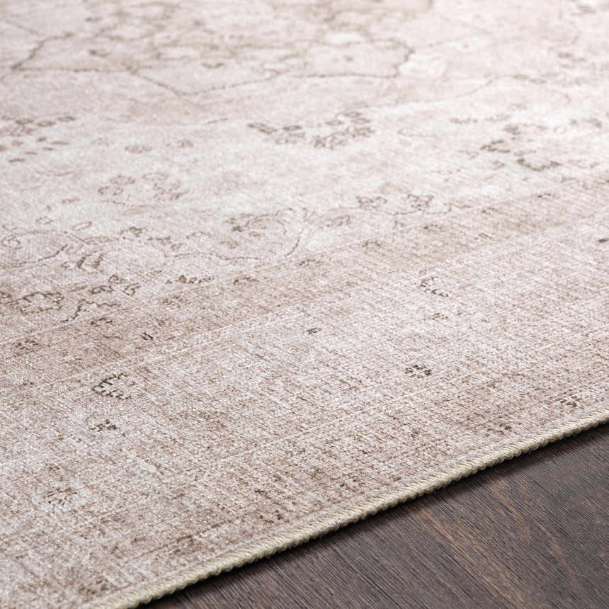 Close-up of the beige Bethany Vintage Flat Pile Washable Rug showing its subtle, traditional pattern and chenille-polyester texture. Pile