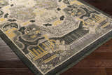 Close-up of the Binger Premium Area Rug. Hand-knotted wool rug with a vintage-inspired design in dark green, ivory, gray, and tan. Corner