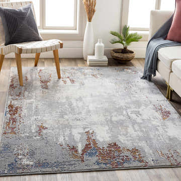 Living room scene with a Bitton Faux Silk Rug in gray, brick red, and charcoal. Contemporary style with a chair and sofa. Roomscene-Rectangle