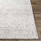 Close-up of the Blackfoot Area Rug showing its white and black traditional, hand-knotted design and viscose texture. Front