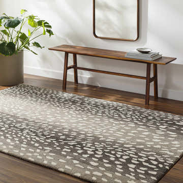 Entryway with beige walls, wood floors, and Athena Giraffe Print Wool Rug. Bench, mirror, and potted plant complete the scene. Roomscene-Rectangle