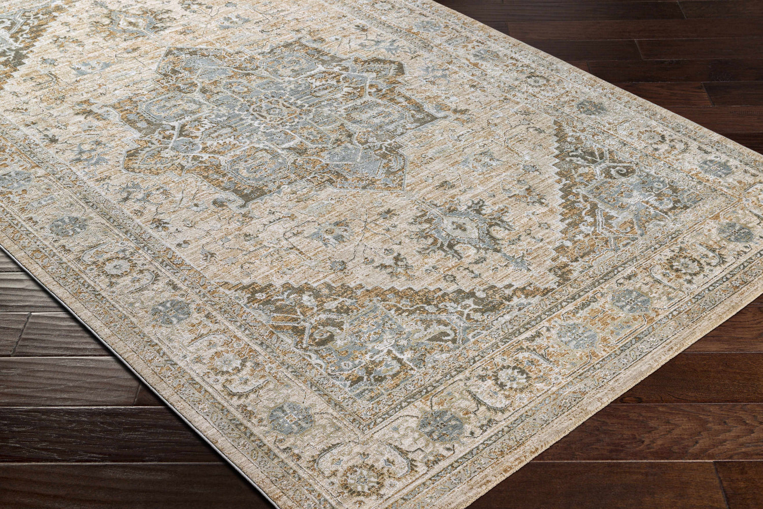 Close-up of Ballisodare Thick Luxe Boutique Rug showing a traditional design in light beige, sage, and teal on dark wood floors. Corner