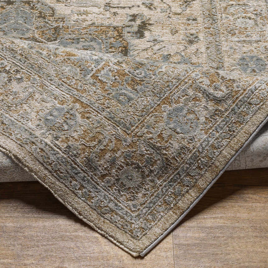 Close-up of the Ballisodare Thick Luxe Boutique Rug showing its traditional pattern and colors: beige, taupe, and dusty sage. Fold
