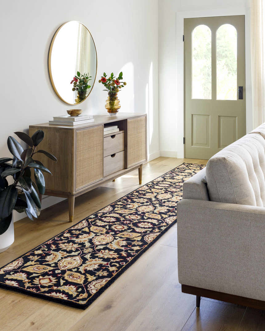 Entryway scene with a Blomkest Black&Yellow Traditional Wool Carpet runner, wood console table, round mirror, and neutral sofa. Roomscene-Runner