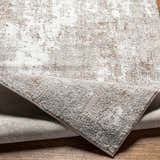 Close-up of the Binabaan Abstract Area Rug featuring a textured charcoal, ivory, and tan abstract design. Fold