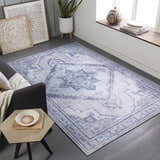 Living room scene with a gray sofa and the ivory and blue Boon Area Rug. Roomscene-Rectangle