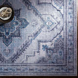 Close-up of the Boon Area Rug, featuring a traditional pattern in ivory, medium gray, navy, and pale blue. Styleshot
