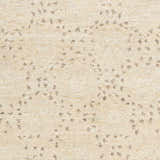 Close-up of the Banksia Area Rug: hand-knotted wool rug in cream with charcoal and brown flecked pattern. Swatch