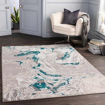Living room scene with a Bonville Blue Marble Rug, cream chair, dark wood floors, and gray walls. Roomscene-Rectangle