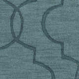 Close-up of the denim Bountiful Area Rug showing its hand-loomed wool texture and contemporary geometric pattern. Swatch