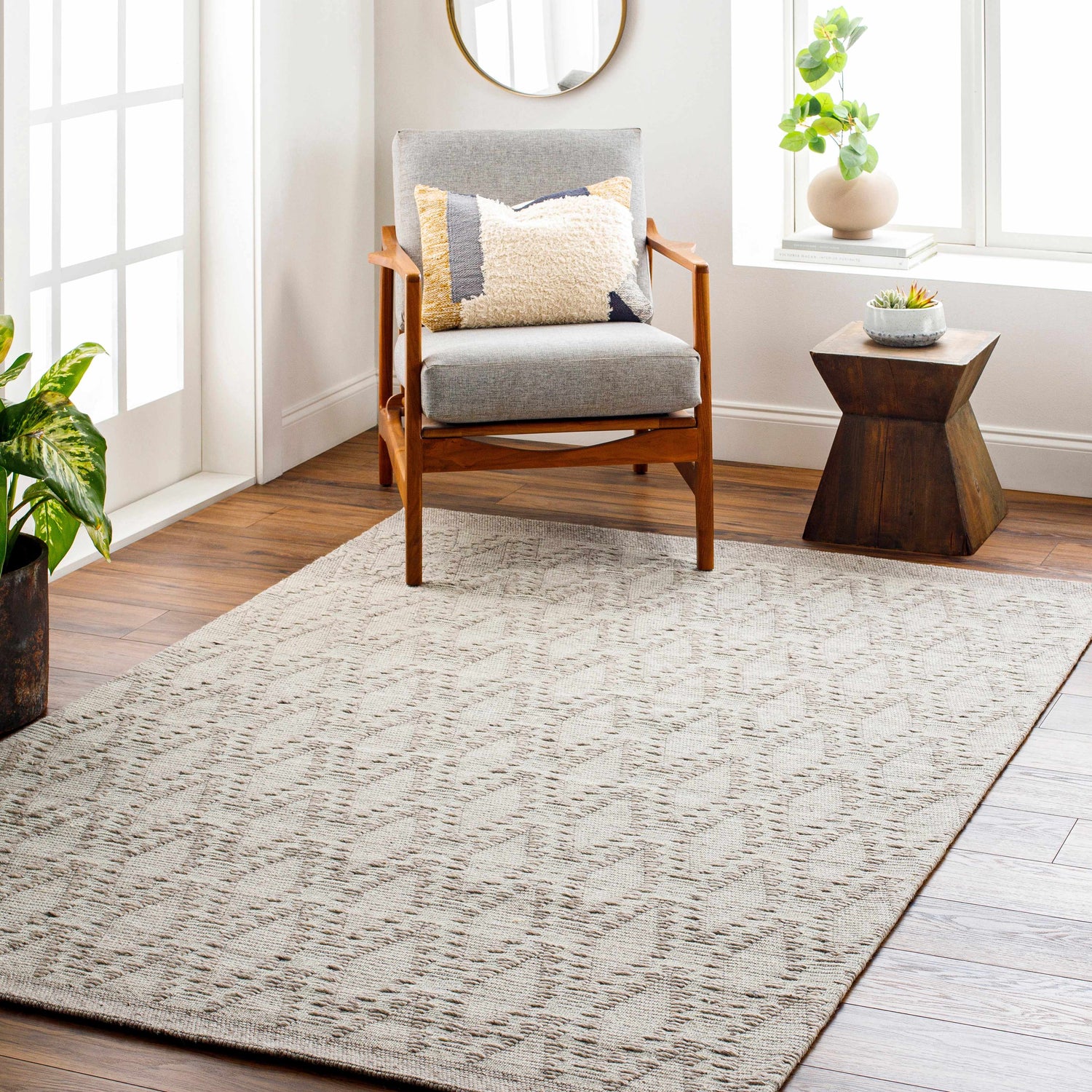 Living room scene with a mocha and off-white Boys Area Rug, gray chair, and wood accents. Farmhouse style. Roomscene-Rectangle