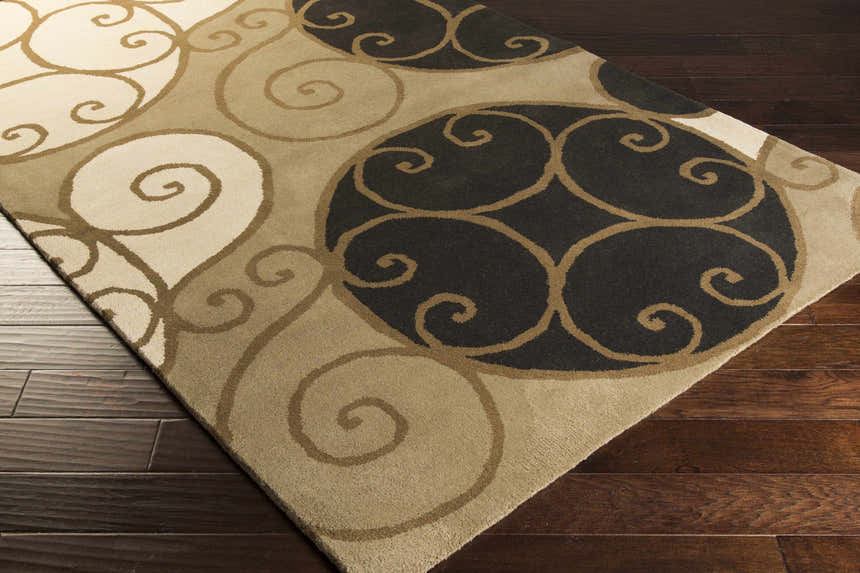 Close-up of the hand-tufted Bray Area Rug. Beige, brown, and black swirls on a wool rug with a contemporary design. Corner