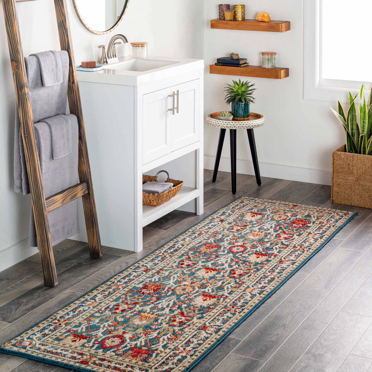 Bathroom scene with Neola Navy Blue Damask Area Rug runner, white vanity, wood ladder with towels, and wood shelves. Roomscene-Runner