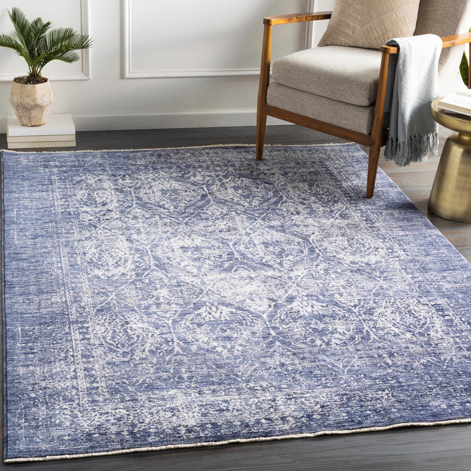 Living room scene with denim and white Barboursville Area Rug, wood chair, side table, and plant. Bohemian style. Roomscene-Rectangle