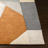 Close-up of the Bracknell Modern Wool Rug. Geometric design with brick red, charcoal, gray, and tan colors. Hand-tufted texture. Front
