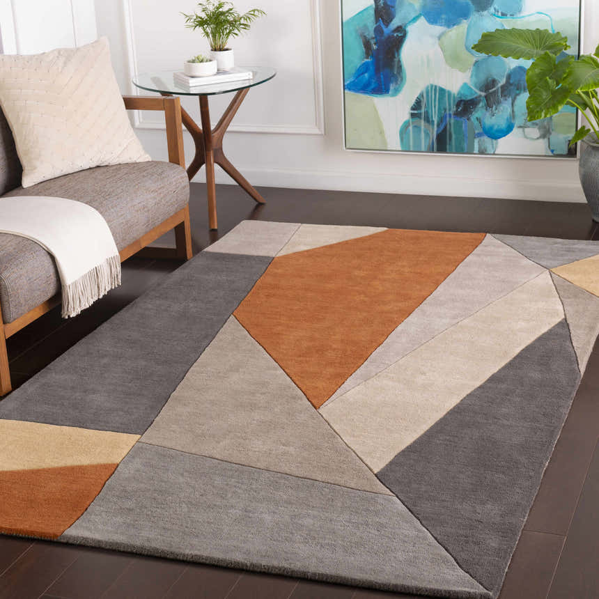 Living room scene with Bracknell Modern Wool Rug. Geometric design in brick red, charcoal, gray, and tan. Mid-century modern style. Roomscene-Rectangle