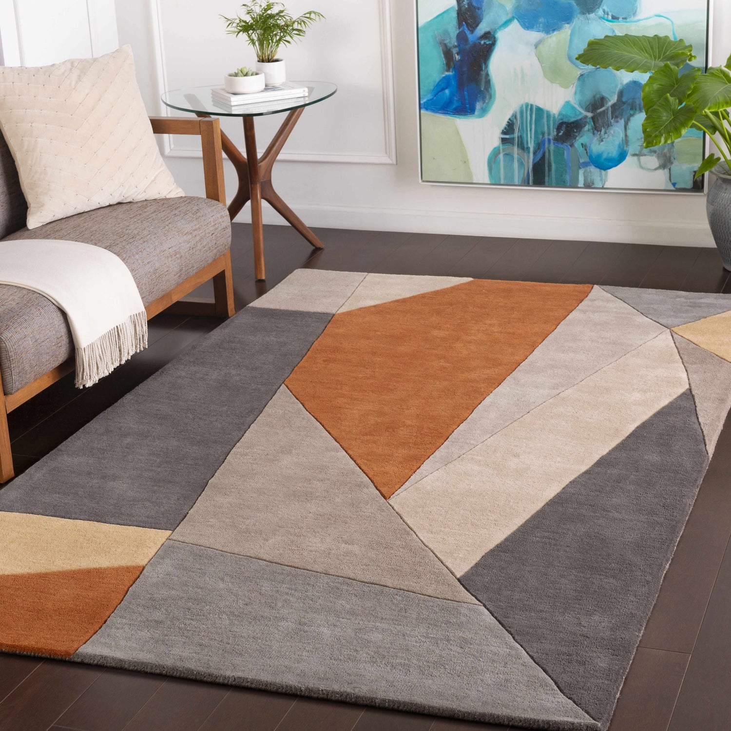 Living room scene with Bracknell Modern Wool Rug. Geometric design in brick red, charcoal, gray, and tan. Mid-century modern style. Roomscene-Rectangle