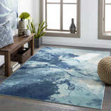 Bright Sky Indoor/Outdoor Rug in a sunlit living room with a wooden bench, woven pouf, and coastal decor. Roomscene-Rectangle