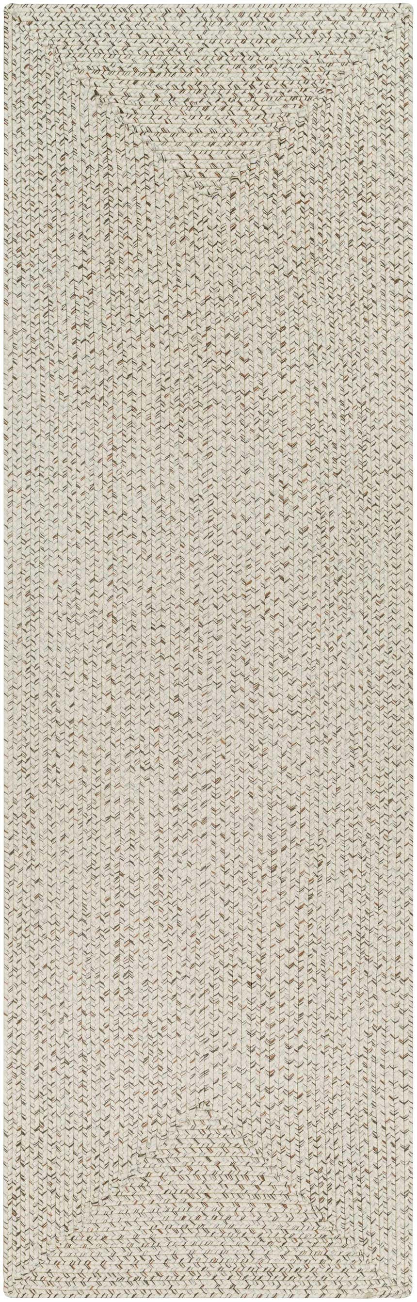 Close-up of a Beige Braided Faux Jute Rug. The rug has a textured, braided design in bleached jute, brown, charcoal, and cream. Design-Runner-268