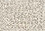 Close-up of the Beige Braided Faux Jute Rug. Braided texture in bleached jute, brown, charcoal, and cream colors. Swatch