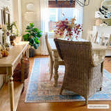 Farmhouse dining room with a Rosman Distressed Washable Area Rug in blue, beige, and brick red under a light wood table. Roomscene-Rectangle