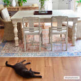 Farmhouse dining room with a Rosman Distressed Washable Area Rug in beige, blue, and brick red under a white table and chairs. Roomscene-Rectangle