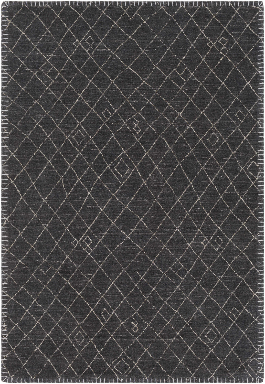 Close-up of the Brimbank Premium Rug. Hand-loomed wool and viscose rug in black and ivory with a geometric diamond pattern. Design-Rectangle-23