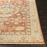 Close up of the hand knotted Brookeland Area Rug. Beige, brick red, and blue oriental rug on dark wood floor. Front
