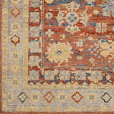 Close-up of the hand-knotted Brookeland Area Rug. Features beige, brick red, and blue floral and geometric designs. Swatch