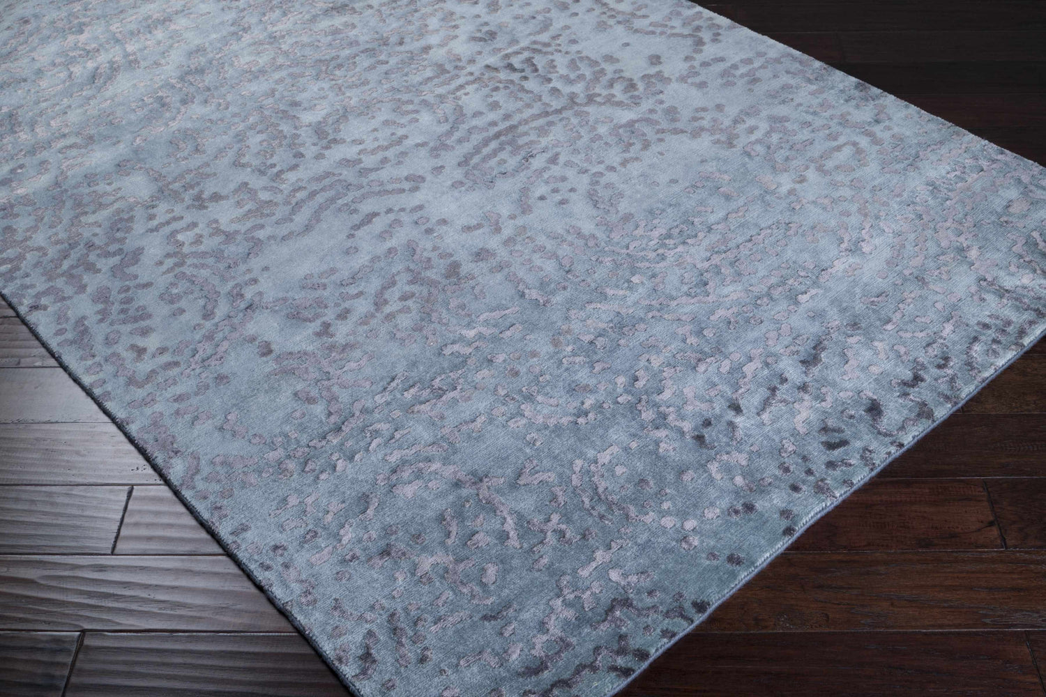 Close-up of the Pensacola Charcoal Rug, a premium wool and viscose rug with a contemporary abstract design. Corner