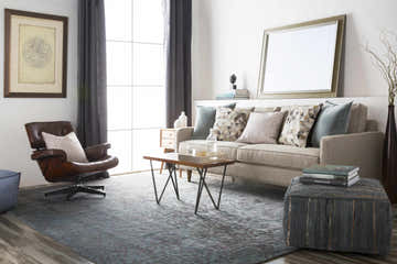 Living room scene with Pensacola 5x8 Charcoal rug, sofa, leather chair, and modern decor. Contemporary style. Roomscene-Rectangle