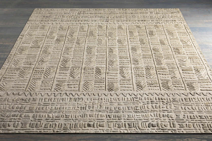 Close-up of the Burlington Clearance Rug showing a raised geometric pattern in dusty sage and oatmeal tones. Styleshot