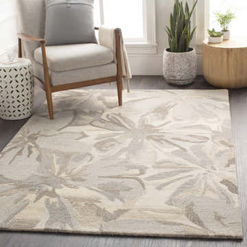 Living room scene with a beige floral Ilfeld Athena wool rug, gray chair, and plants. Roomscene-Rectangle