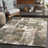 Living room scene with a Bronx Area Rug in cream, teal, brown, and gray. Modern console table and gray chair. Roomscene-Rectangle