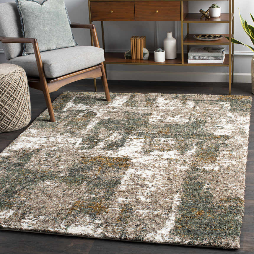 Living room scene with a Bronx Area Rug in cream, teal, brown, and gray. Modern console table and gray chair. Roomscene-Rectangle
