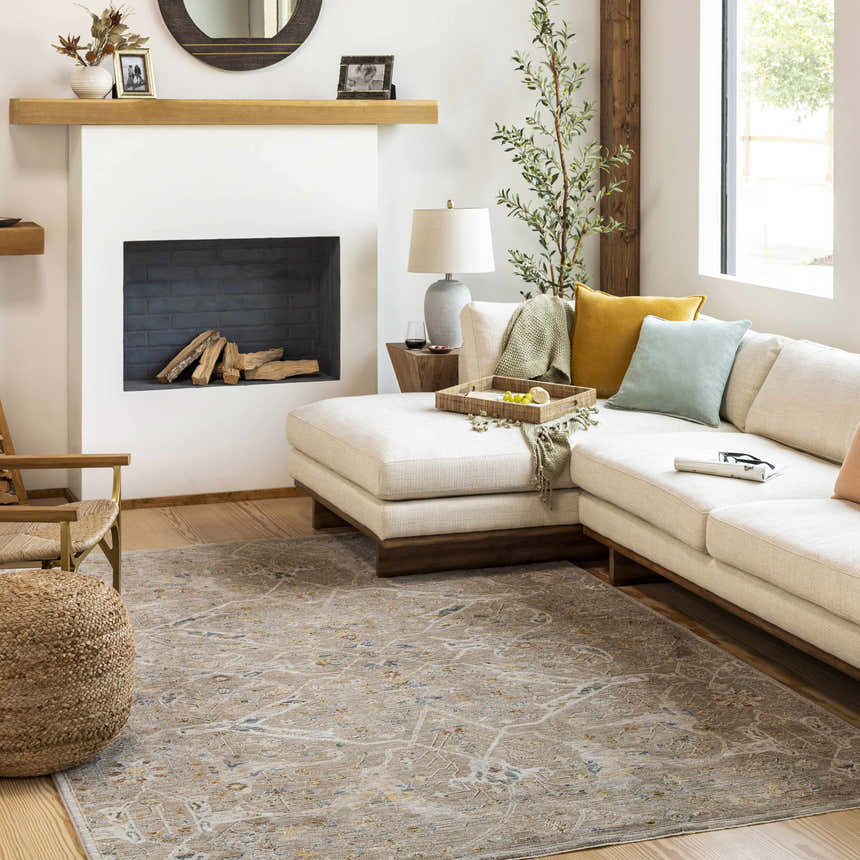 Living room scene with a Barneyside Luxe Area Rug, cream sofa, fireplace, and natural light. Roomscene-Rectangle