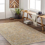 Entryway with a Barneyside Luxe Area Rug in tan, cream, and blue, styled with a wood bench, hat, and shoes. Roomscene-Rectangle