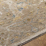 Close-up of the Barneyside Luxe Area Rug showing its tan, cream, blue and mustard floral pattern and textured weave. Texture