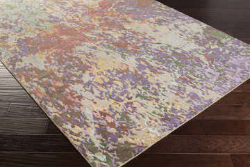 Close-up of the Bronxville Area Rug showing its dark brown, lavender, lilac, olive, and peach abstract design. Corner