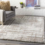 Living room scene with cream Broulee Abstract Striped Plush Rug, gray chair, and white brick fireplace. Roomscene-Rectangle