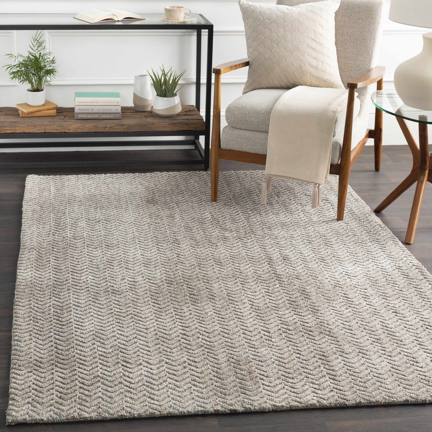Living room scene with a Broxton carpet in aqua, brown, and taupe. Contemporary rug under a chair and side tables. Roomscene-Rectangle