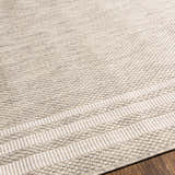 Close-up of the woven texture and bordered design of the beige and gray Burradoo Area Rug. Texture