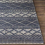 Close-up of the hand woven Bunclody Jute Carpet. Light beige and navy geometric pattern on a textured jute rug. Front